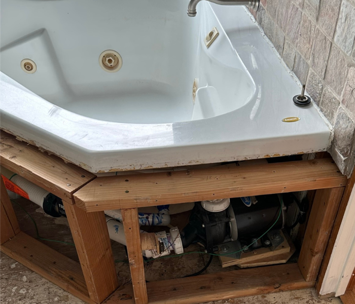 the inside of a bathtub with the internal structure intact and the outside tiles and flooring removed