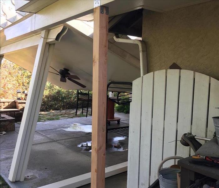 collapsed patio from rain storm  