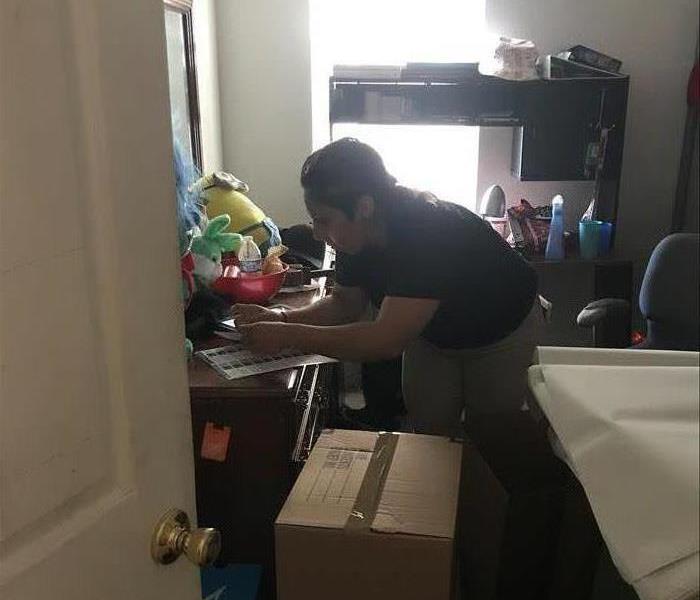 SERVPRO team packing up bedroom after a water loss 